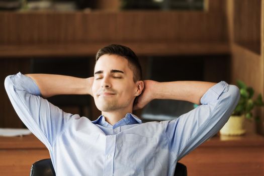 Male marketing manager resting and smiling while working to reduce drowsiness