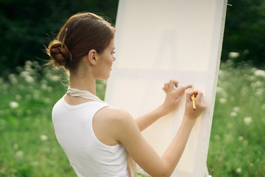 women outdoors near easel creative art drawing. High quality photo