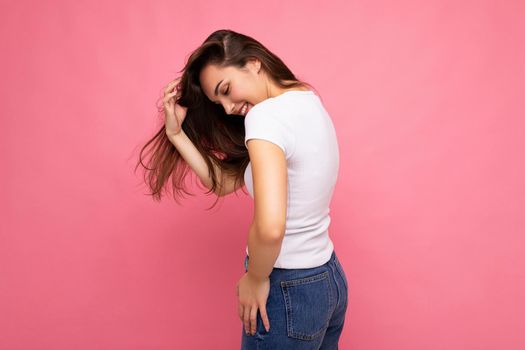 Side-profile photo shot of cute nice charming gorgeous attractive pretty youngster happy woman wearing white t-shirt for mockup isolated over colorful background with copy space.