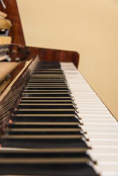 Piano keyboard background with selective focus. Warm color toned image