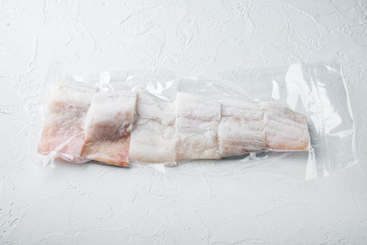 Haddock fish skinless in vacuum package, on white background with copy space for text