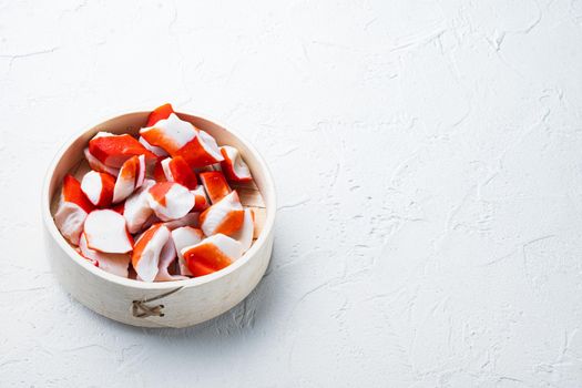 Crab sticks seafood semi finished fish mince with blue swimming crab set, on wooden tray, on white background , with copyspace and space for text