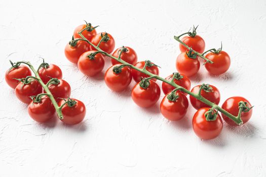 Ripe branch of cherry tomatoes set, on white stone background