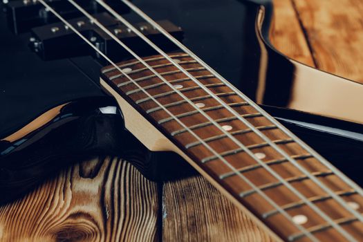 Close up photo of electric guitar fingerboard on dark background