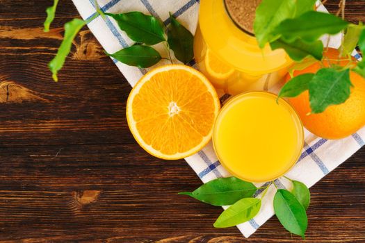 Glass of orange juice on wooden table