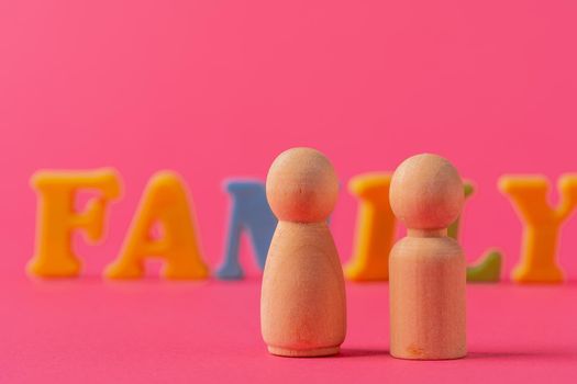 Wooden little figures of people close up. Family concept