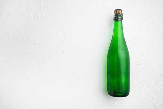 Green wine bottle set, on white stone table background, top view flat lay, with copy space for text
