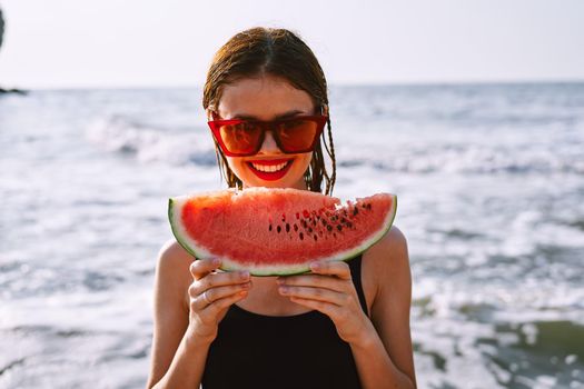 woman in swimsuit with watermelon outdoors sun fresh air. High quality photo