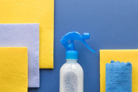 House cleaning and housekeeping concept on blue background. Detergents for cleaning or disinfecting the room.