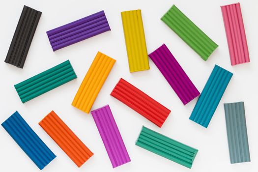 Colorful plasticine sticks on light background