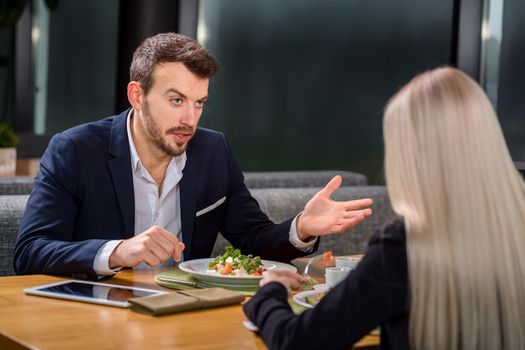 A woman and a man on a business lunch in a restaurant