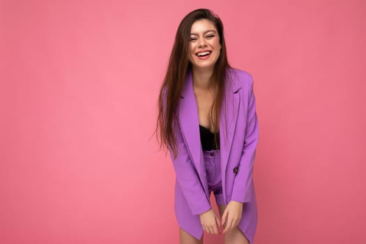 Young happy smiling brunette woman nice-looking attractive charming elegant fashionable wearing stylish suit with jacket isolated over pink background with copy space.