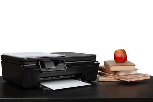 Working table with printer and stacked books on white abckground, close up
