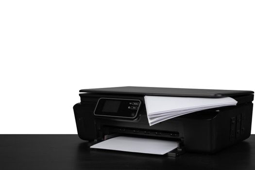 Laser home printer on table against white background, close up