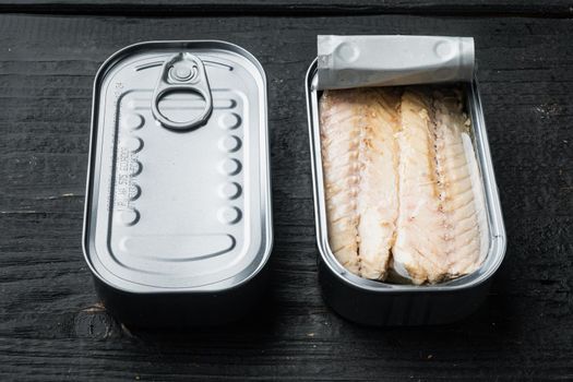 Canned Mackerel Fillets in Tin set, in tin can, on black wooden table background