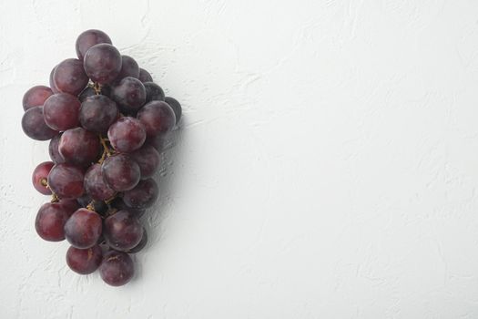 Natural organic juicy grapes set, dark red fruits, on white stone background, top view flat lay, with copy space for text