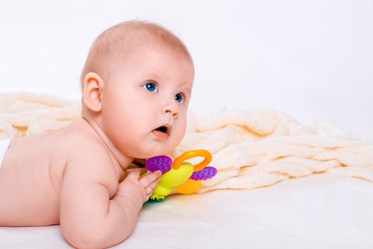 Cute baby girl on white background. Baby in diaper with toy