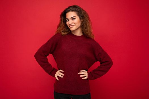 Photo of beautiful positive smiling adult woman wearing stylish clothes standing isolated on colorful background with copy space looking at camera.