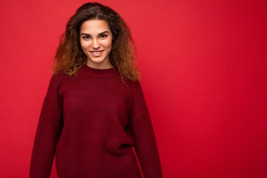 Photo of beautiful positive smiling adult woman wearing stylish clothes standing isolated on colorful background with copy space looking at camera.