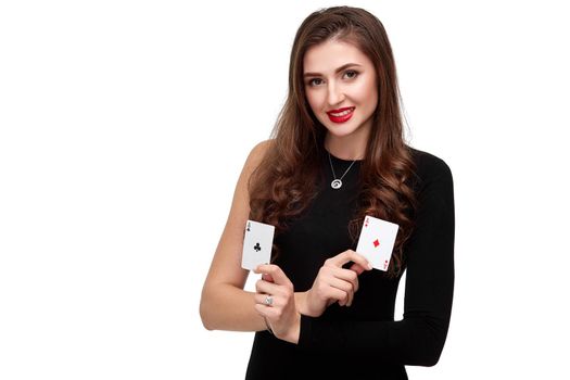 Sexy curly hair brunette in black dress posing with two aces cards in her hands, poker concept isolation on white background. winning combination