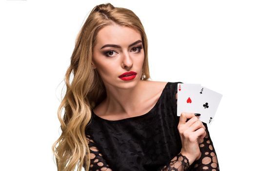 Beautiful blonde in a black dress with casino cards two aces in hands isolated on a white background. Poker. Casino. Roulette Blackjack Spin. Caucasian young woman looking at the camera. Winning combination
