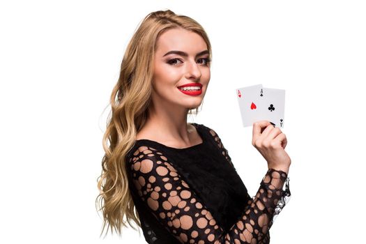 Beautiful blonde in a black dress with casino cards two aces in hands isolated on a white background. Poker. Casino. Roulette Blackjack Spin. Caucasian young woman looking at the camera. Winning combination