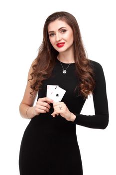 Sexy curly hair brunette in black dress posing with two aces cards in her hands, poker concept isolation on white background. winning combination