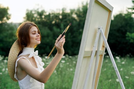 woman artist outdoors painting nature hobby art. High quality photo