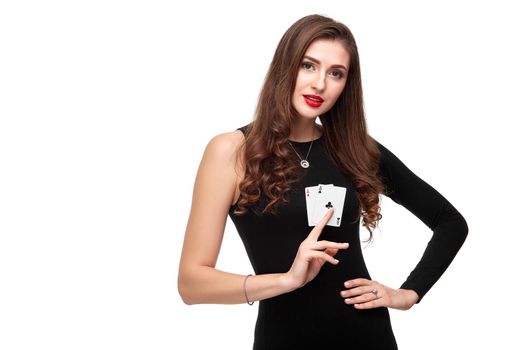 Sexy curly hair brunette in black dress posing with two aces cards in her hands, poker concept isolation on white background. winning combination