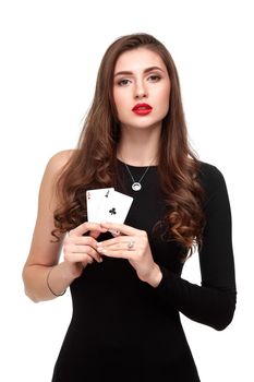 Sexy curly hair brunette in black dress posing with two aces cards in her hands, poker concept isolation on white background. winning combination