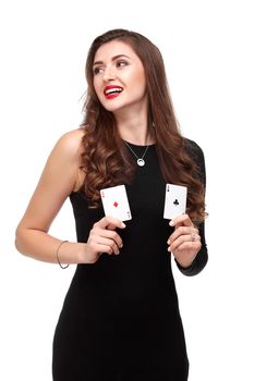 Sexy curly hair brunette in black dress posing with two aces cards in her hands, poker concept isolation on white background. winning combination