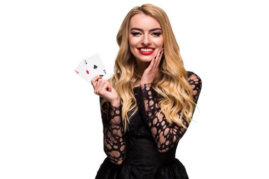 Beautiful blonde in a black dress with casino cards two aces in hands isolated on a white background. Poker. Casino. Roulette Blackjack Spin. Caucasian young woman looking at the camera. Winning combination