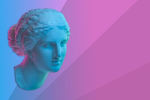 Statue of Venus de Milo. Creative concept colorful neon image with ancient greek sculpture Venus or Aphrodite head. Pink and blue duotone effects. Webpunk, vaporwave and surreal art style.