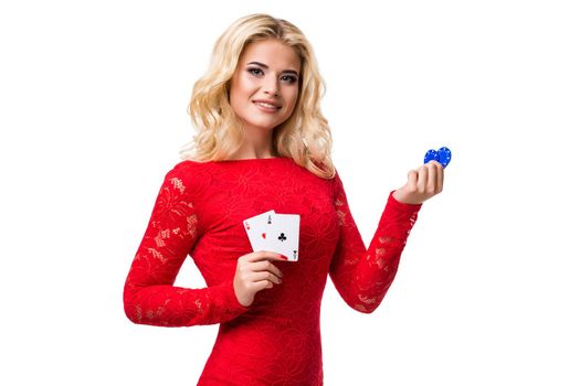 Caucasian young woman with long light blonde hair in evening outfit holding playing cards and chips. Isolated on white background. Poker