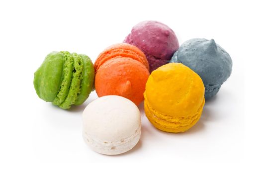 Pile of colorful meringue cookies isolated on white background