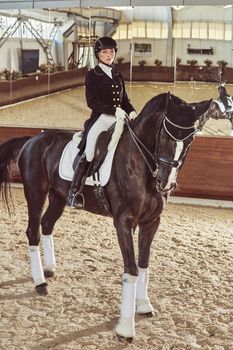 woman jockey with his horse in uniform for Dressage