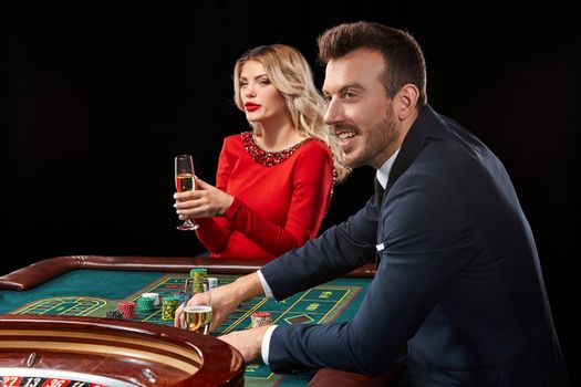 Couple playing roulette wins at the casino. Addiction to the gambling