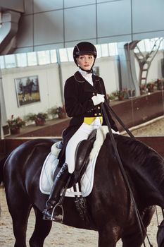 woman jockey with his horse in uniform for Dressage