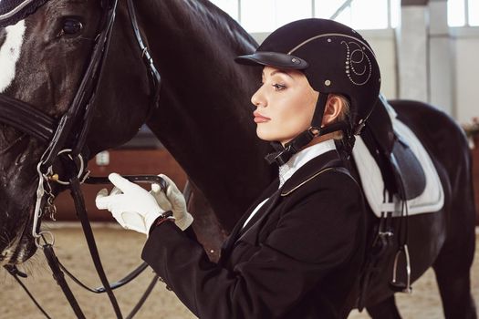 woman jockey with his horse in uniform for Dressage