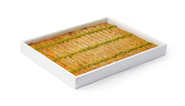 Assortment of Turkish baklava dessert in a white box isolated on white background