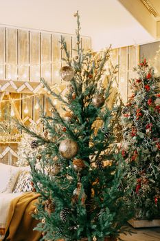 Home Christmas interior, with a Christmas tree and lots of glowing garlands and light bulbs. Preparing for the Christmas party at home.