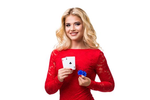 Caucasian young woman with long light blonde hair in evening outfit holding playing cards and chips. Isolated on white background. Poker