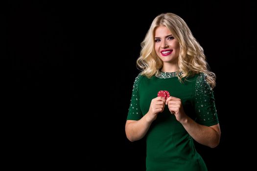 blonde woman posing with chips for gambling on black background