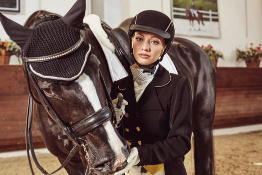 woman jockey with his horse in uniform for Dressage