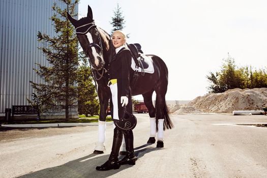 woman jockey with his horse in uniform for Dressage