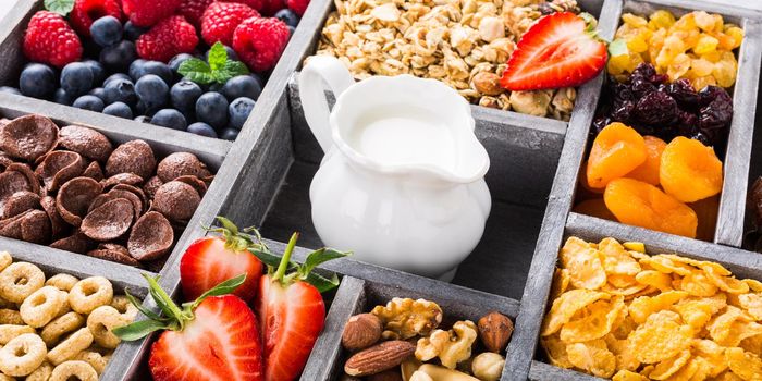 Old gray wooden box with variety of cold quick breakfast cereals and berries for breakfast, healthy eating concept, selective focus.