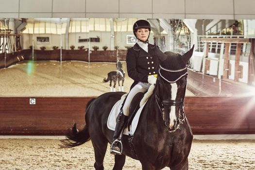 woman jockey with his horse in uniform for Dressage