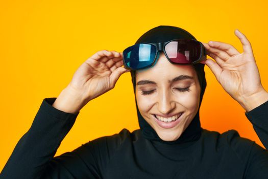 cheerful woman watching movies 3D glasses fun yellow background. High quality photo
