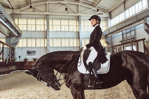 woman jockey with his horse in uniform for Dressage