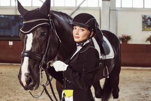 woman jockey with his horse in uniform for Dressage